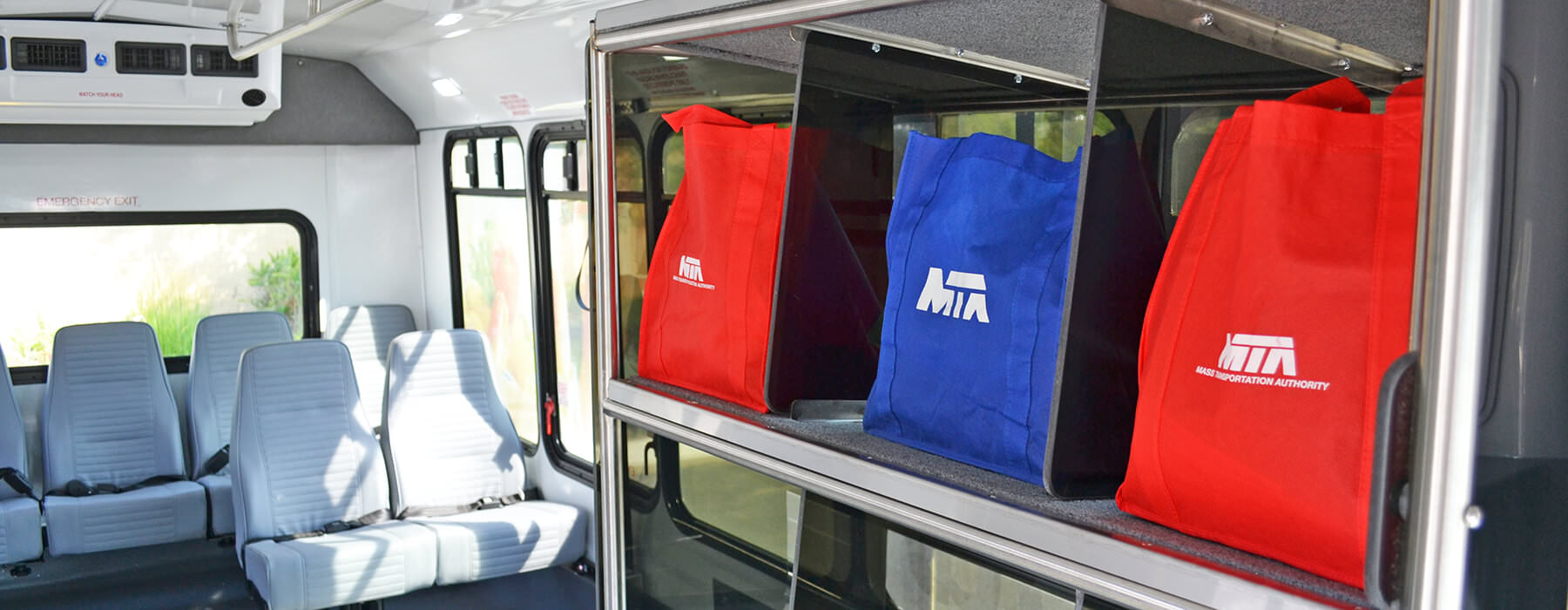 Ride to Groceries bus showing bins to hold grocery bags while traveling.